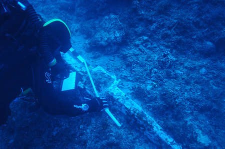 New international mission ready to explore Antikythera shipwreck - Archaeology Theotokis Theodoulou examines the ship's lead anchor stock, about 1.4 metres long and weighing close to 200kg