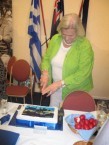 Eva Wilson, (nee, Faros), a real Karavitisa, cuts the cake of Kythera & Karavas. 