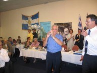 George Kalligeros, proprietor of the Kapsali Restaurant applauds the audience in acknowlgement, for singing.... 