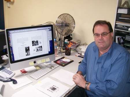 Mark Drolc, graphic designer, working on the book Life in Australia 