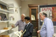 Takis Efstathiou, Bon Koizumi, and Leon Miller examining photographs in the Hearn collection at Tulane University 