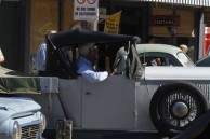 A proud owner parks his vintage car in the display 