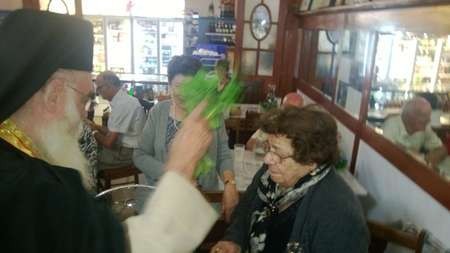 Mrs Diamanta Cassimatis, (nee) Stathis, receiving a blessing during the Canberra cafe celebrations 