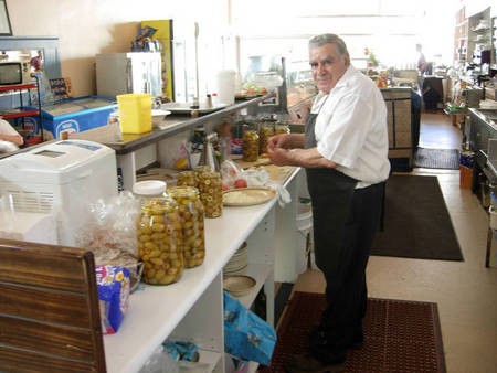 Paul Kalokerinos' & family,  Kytherian generosity. - PP Paul Kalokerinos behind counter Canberra Cafe Manilla