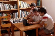 Children enjoy playing with an Ipad in the Library. 