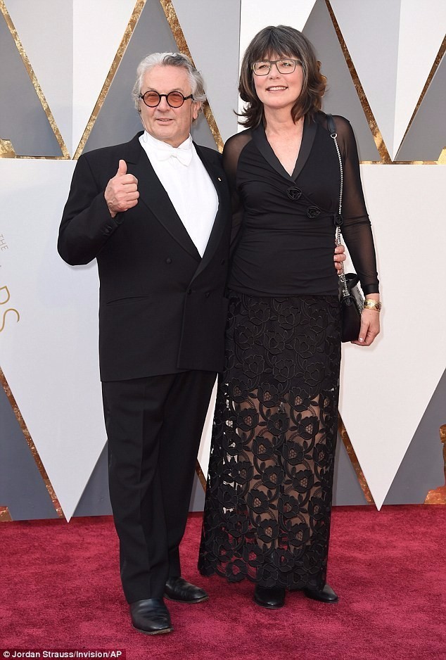 Mad Max director George Miller gives a cheery thumbs up as he arrives at the Oscars with wife Margaret Sixel after his film is nominated for ten gongs 