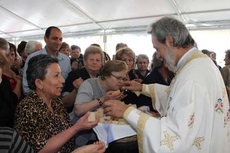 His Grace, Bishop Seraphim, distributing the holy bread - 014 Saint Harry Fourteen