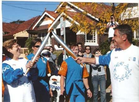 Nicholas (Nick) George Politis - RITA COMINO HANDS OVER OLYMPIC FLAME TO NICK POLITIS IN BAY STREET BRIGHTON LE SANDS JUNE 4 2004. SYDNEY AUSTRALIA