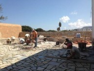 Laying the "coritzo'' tiles in the courtyard of the Kytherian Municipal Library 